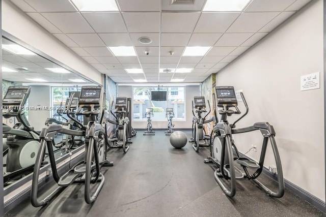 exercise room featuring a paneled ceiling