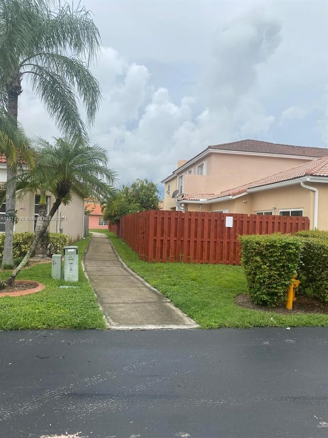 view of side of property with a yard