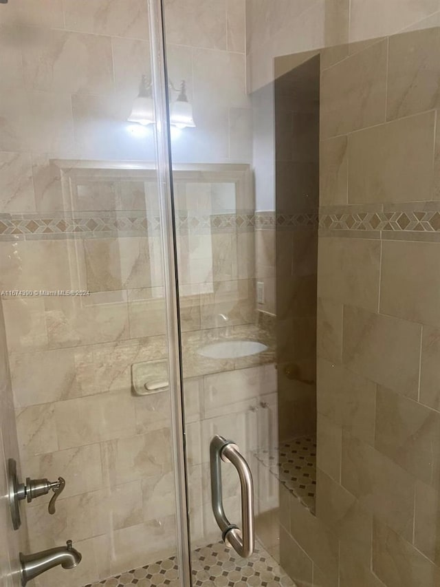 bathroom featuring a shower with door