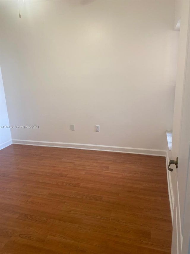 spare room featuring dark hardwood / wood-style flooring