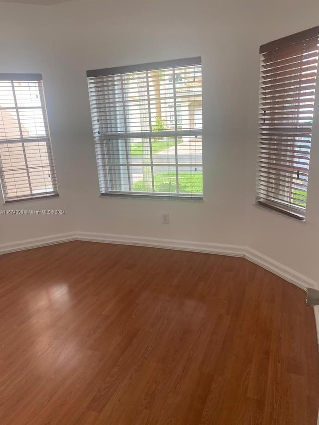 unfurnished room featuring wood-type flooring