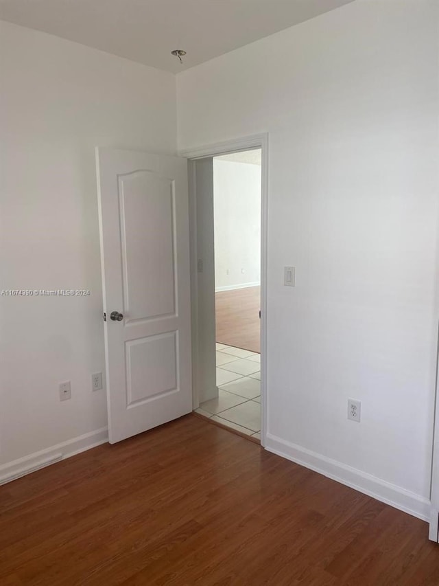 unfurnished room with dark hardwood / wood-style floors