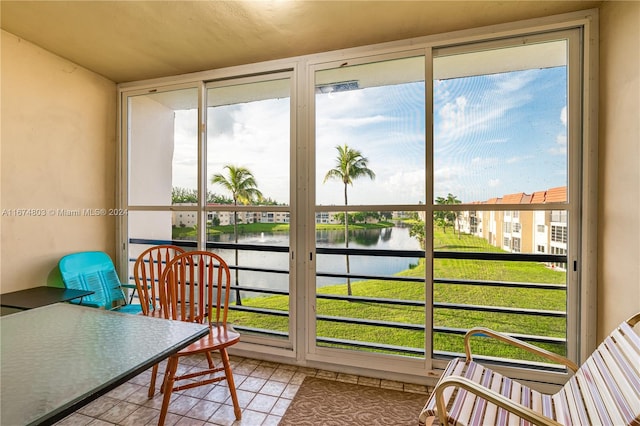 sunroom / solarium with a water view