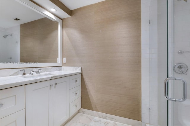 bathroom featuring vanity and an enclosed shower