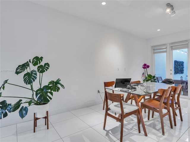 tiled dining area featuring french doors