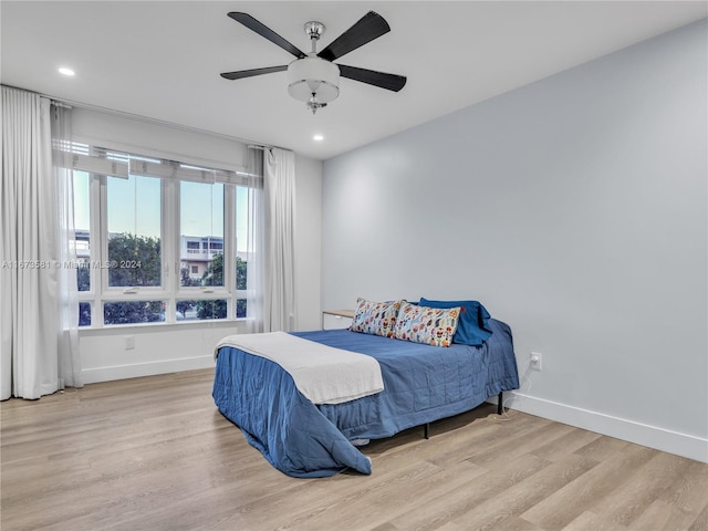 bedroom featuring light hardwood / wood-style floors and ceiling fan