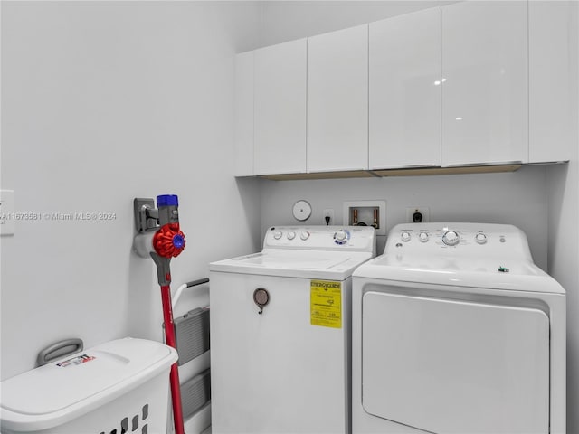 laundry room with cabinets and washing machine and dryer