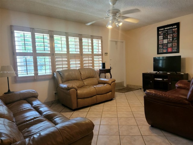 tiled living room with ceiling fan and a textured ceiling