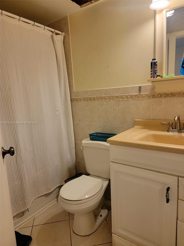 full bathroom with vanity, shower / bath combination with curtain, tile walls, tile patterned flooring, and toilet