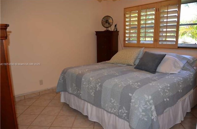 1900 NE 8th Ct Unit 203, Fort Lauderdale, FL 33304 - bedroom with light tile patterned floors and baseboards