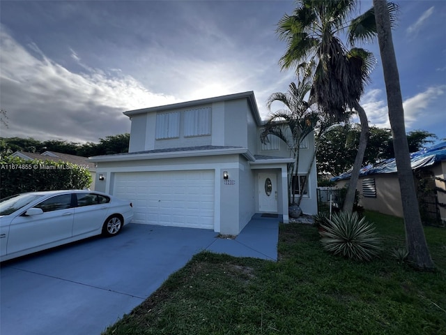 view of front facade featuring a garage and a front lawn