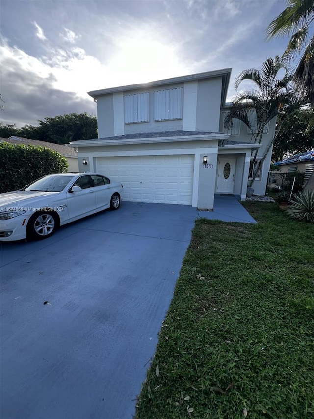 view of front property featuring a garage and a front lawn