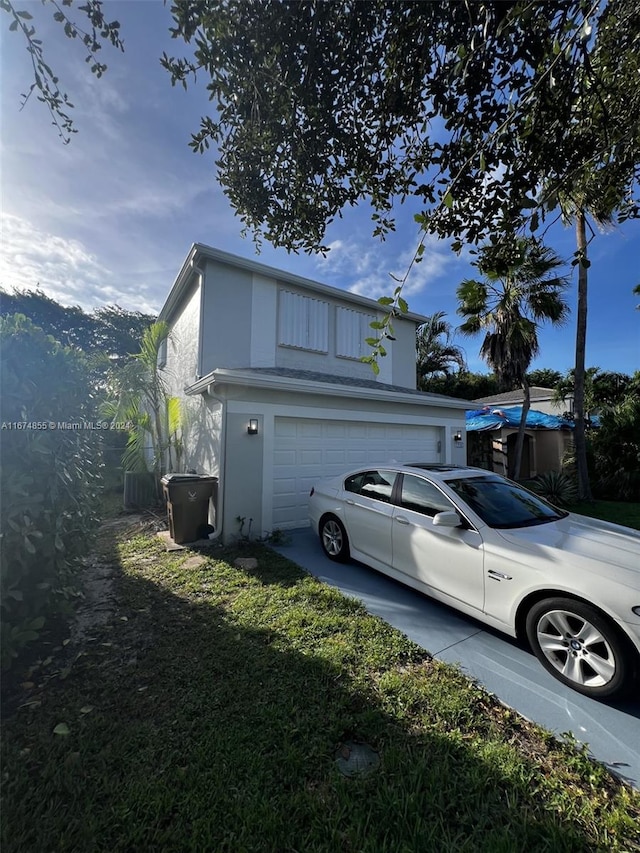 view of home's exterior with a garage and a yard