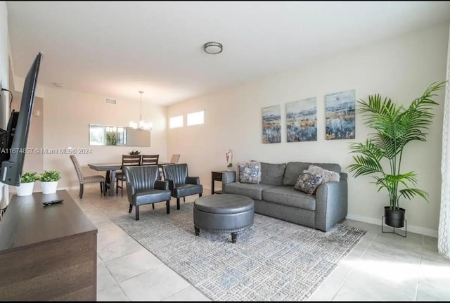 living room featuring an inviting chandelier and light tile patterned floors