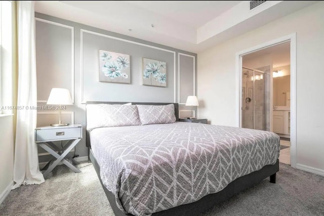 carpeted bedroom featuring ensuite bathroom