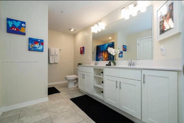 bathroom with vanity, tile patterned flooring, and toilet