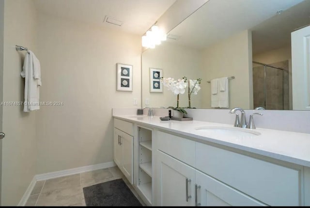 bathroom featuring tile patterned flooring, walk in shower, and vanity