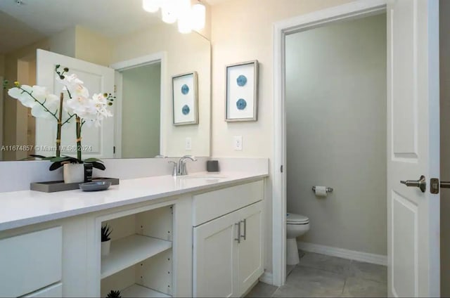 bathroom with tile patterned floors, vanity, and toilet