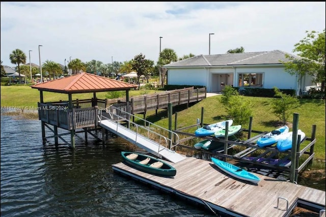 view of dock featuring a gazebo, a yard, and a water view