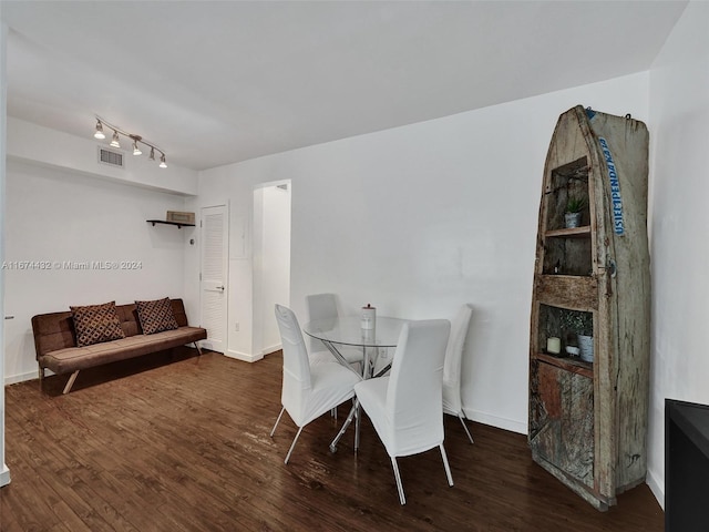 dining area featuring dark wood-type flooring