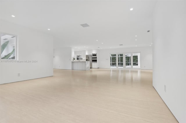 unfurnished living room with light hardwood / wood-style flooring