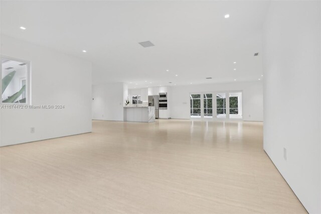 145 S Prospect Dr, Coral Gables, FL 33133 - unfurnished living room featuring recessed lighting and light wood-style floors