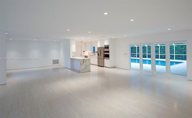 unfurnished living room featuring light hardwood / wood-style flooring