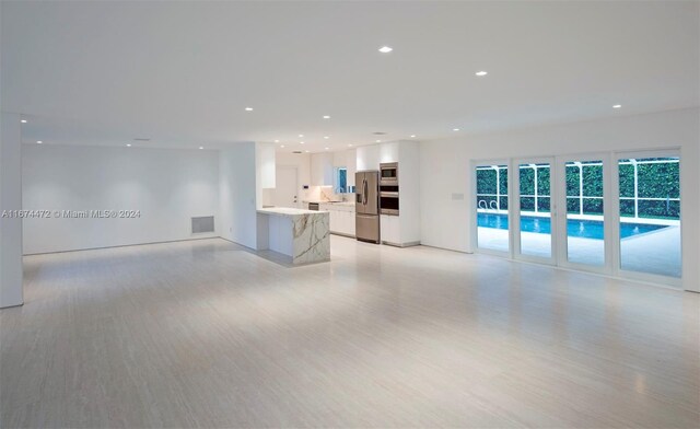 145 S Prospect Dr, Coral Gables, FL 33133 - unfurnished living room with light wood-type flooring and recessed lighting