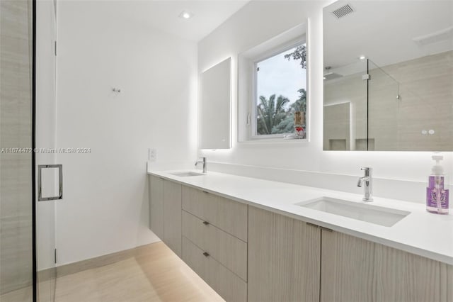 bathroom featuring vanity and an enclosed shower