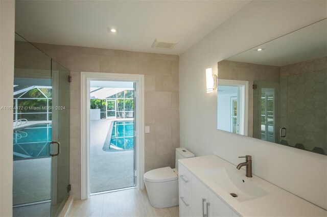 145 S Prospect Dr, Coral Gables, FL 33133 - bathroom with tile walls, vanity, a shower stall, and recessed lighting