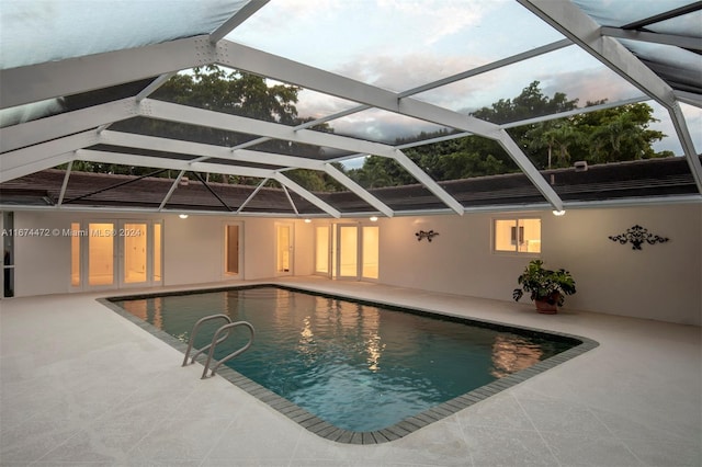 view of swimming pool with a lanai and a patio area