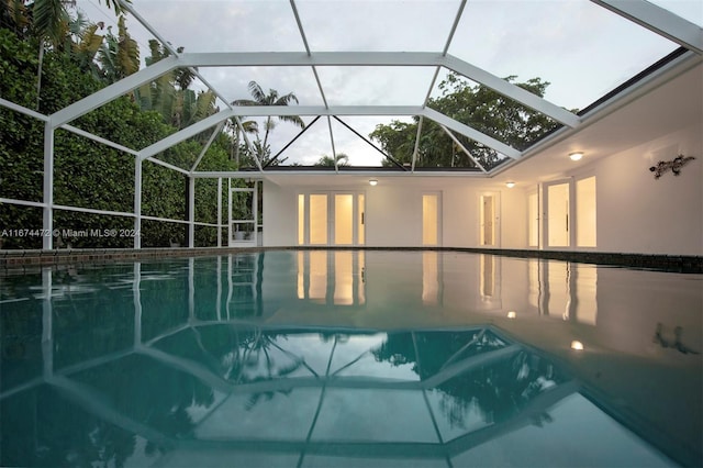 view of pool with glass enclosure