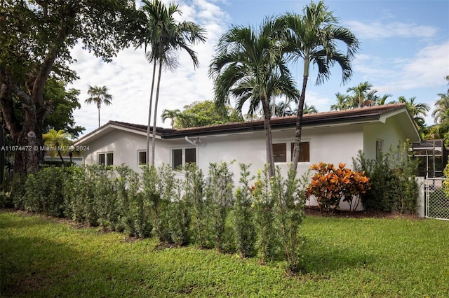 view of property exterior with a lawn