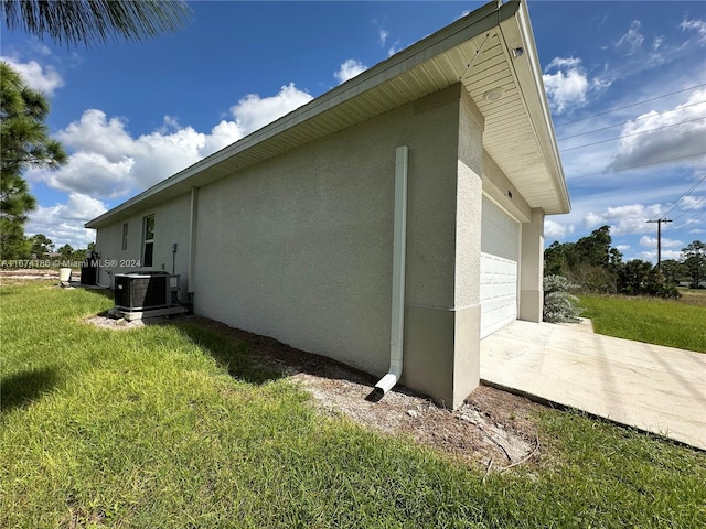 view of side of home with cooling unit and a lawn