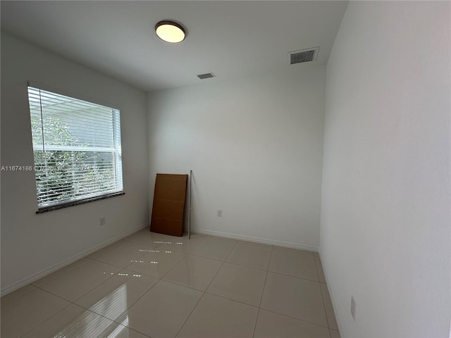 spare room featuring light tile patterned floors