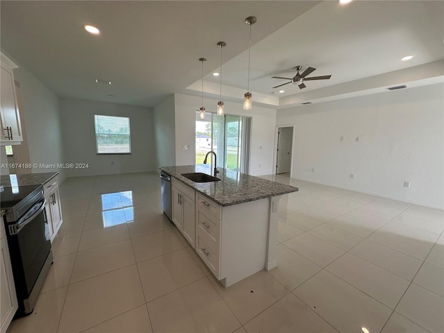 kitchen featuring white cabinetry, appliances with stainless steel finishes, sink, and an island with sink