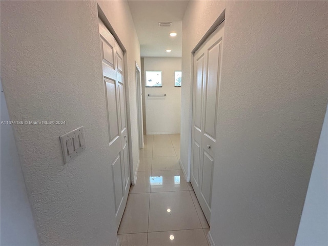 corridor with light tile patterned floors