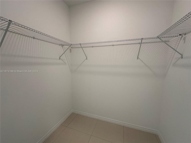 spacious closet with tile patterned floors