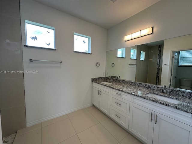 bathroom with vanity, toilet, and tile patterned flooring