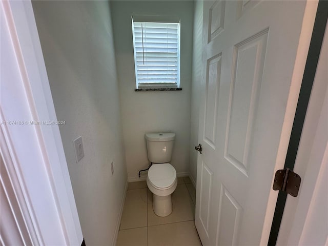 bathroom with toilet and tile patterned flooring