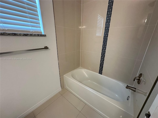 bathroom featuring tiled shower / bath combo and tile patterned flooring