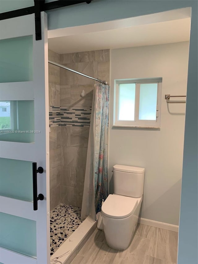 bathroom with toilet and walk in shower