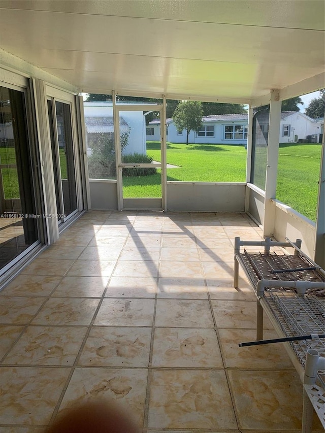 unfurnished sunroom featuring plenty of natural light