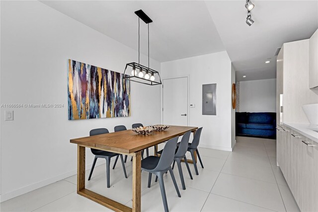 dining area featuring electric panel and light tile patterned floors