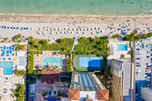 aerial view with a water view and a beach view