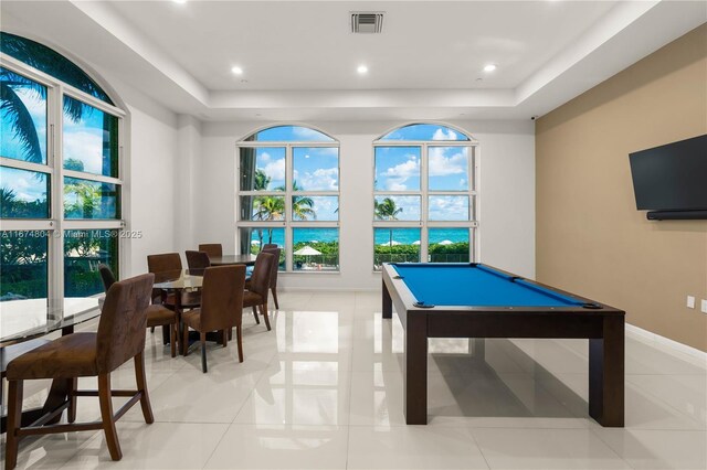 playroom featuring light tile patterned flooring, pool table, and a tray ceiling