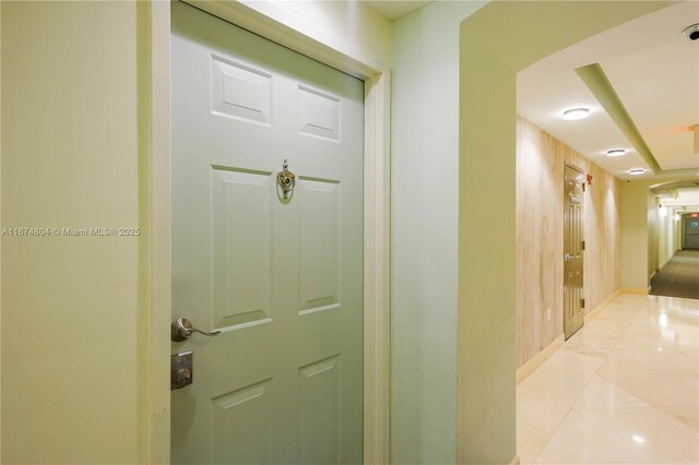 corridor featuring light tile patterned floors