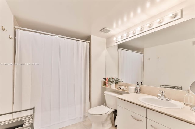 bathroom featuring toilet, tile patterned floors, and vanity