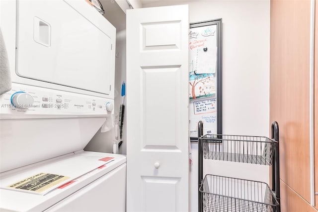 laundry area with stacked washer / drying machine