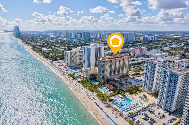 birds eye view of property with a water view and a view of the beach